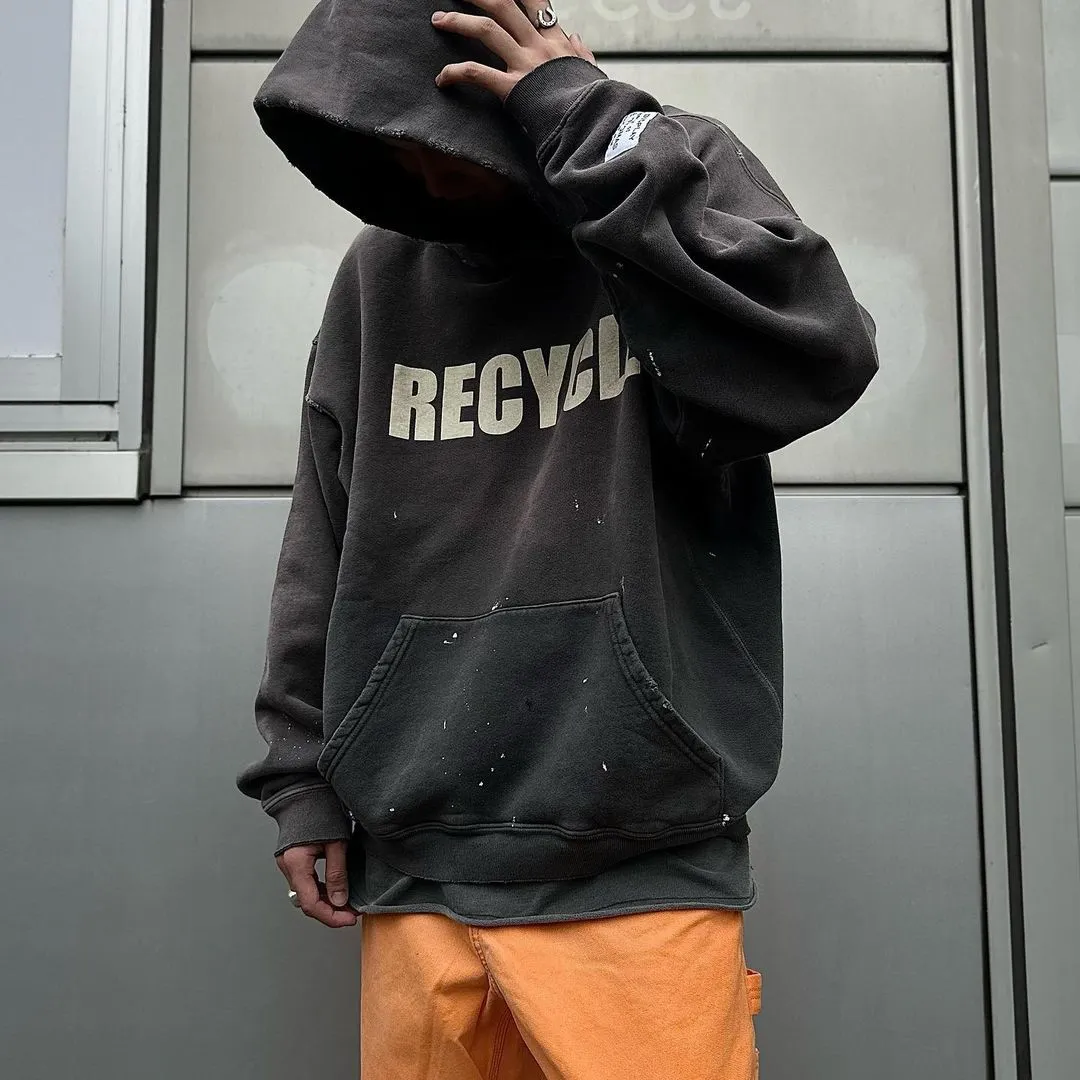 GALLERY DEPT. 90'S RECYCLE HOODIE WASHED BLACK 90'S washed hoodie with distressed eco-friendly slogans. Washed black S-XL. Ready-made garments are washed and dyed again. Multiple spots throughout the body are spray-faded. The ribs are cut and worn.